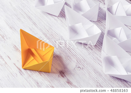 Business leadership concept with white and color paper boats on Business leadership concept with white and color paper boats on 48858163