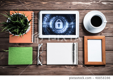 Web security and technology concept with tablet pc on wooden tab Web security and technology concept with tablet pc on wooden tab 48858166