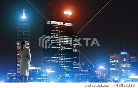 Woman looking at night city 48858319