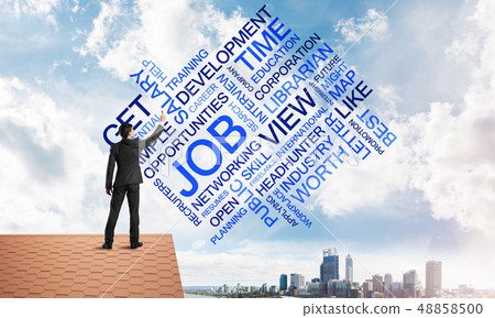 Young businessman standing on house roof and writing leadership skill concept. Mixed media 48858500