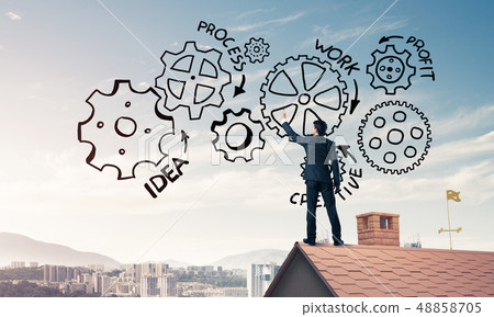 Mister boss on brick roof standing with back and draw teamwork c 48858705
