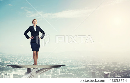 Confident elegant businesswoman presented on metal tray against cityscape background Confident elegant businesswoman presented on metal tray against cityscape background 48858754