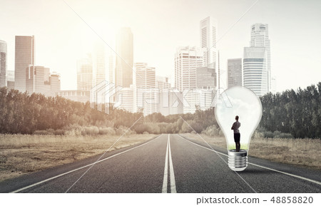 Businesswoman inside light bulb Businesswoman inside light bulb 48858820