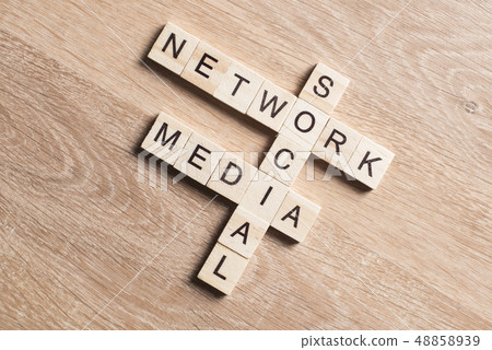 Conceptual media keywords on table with elements of game making crossword Conceptual media keywords on table with elements of game making crossword 48858939