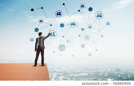 Businessman on house roof presenting networking and connection concept. Mixed media 48860400