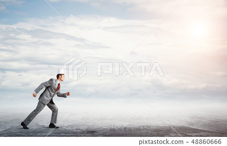 King businessman in elegant suit running and blue sky at background 48860666