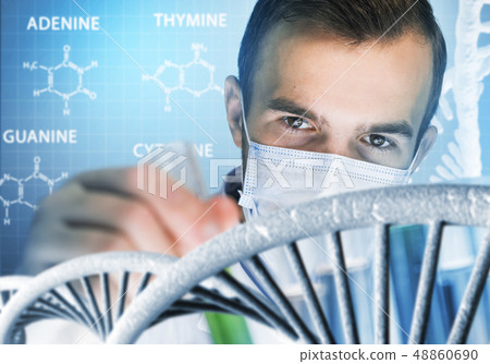 Young scientist mixing reagents in glass flask in clinical laboratory 48860690