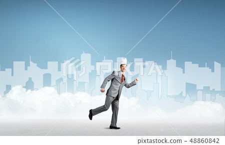 King businessman in elegant suit running and blue cityscape silhouette at background 48860842