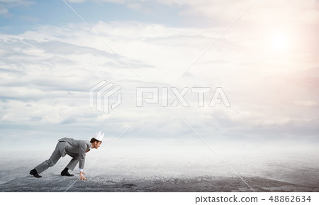 King businessman in elegant suit running and blue sky at background 48862634