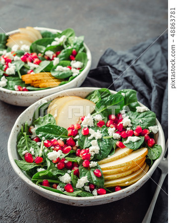 Vegan salad bowl with spinach, pear, pomegranate, cheese Vegan salad bowl with spinach, pear, pomegranate, cheese 48863781