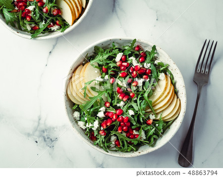 Vegan salad bowl with arugula, pear, pomegranate, cheese 48863794