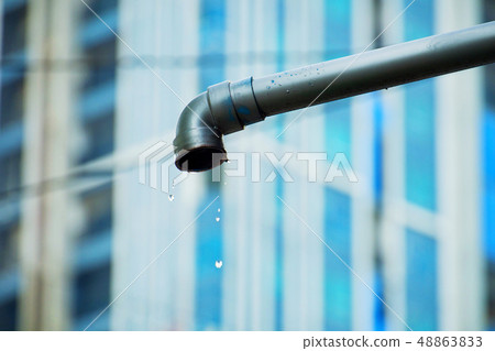 Water droplets flow out from the steel sewer. Water droplets flow out from the steel sewer. 48863833