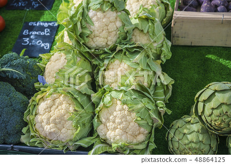 Fresh cauliflower, broccoli and artichoke on the Fresh cauliflower, broccoli and artichoke on the 48864125