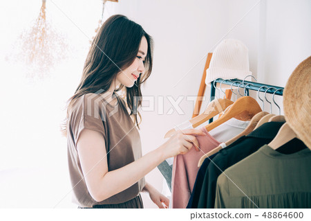 A woman choosing clothes A woman choosing clothes 48864600