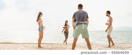 Group of friends playing at the beach on summer 48864699