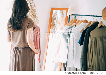 A woman choosing clothes A woman choosing clothes 48865135