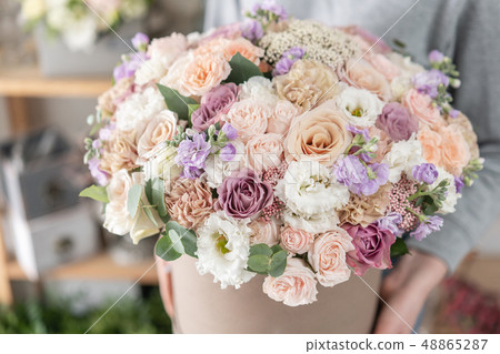 beautiful fresh cut bouquet of mixed flowers in woman hand. the work of the florist at a flower shop 48865287