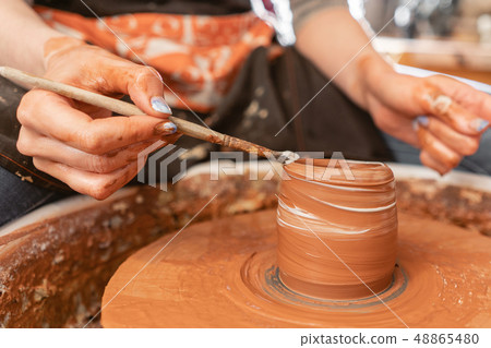Craftsman hands making pottery bowl. Woman working on potter wheel . Family business shop sculpts 48865480