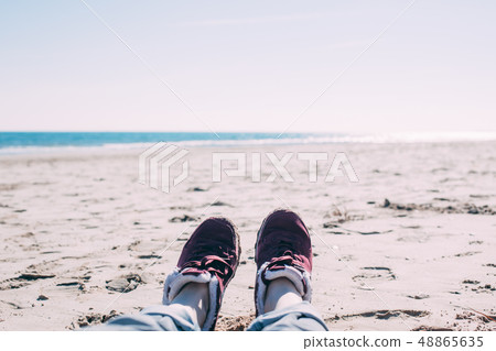 Girl relaxing on sand beach 48865635