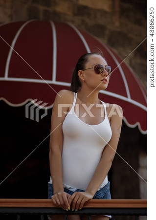Sensual woman in swimwear near pillar Sensual woman in swimwear near pillar 48866250