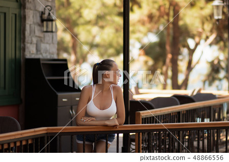 Sensual woman in swimwear near pillar Sensual woman in swimwear near pillar 48866556