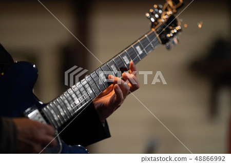 Guitar play (focus on the left hand ring finger) Guitar play (focus on the left hand ring finger) 48866992