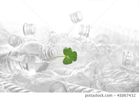 Many plastic bottles and green leaves stacked on a white background Many plastic bottles and green leaves stacked on a white background 48867432