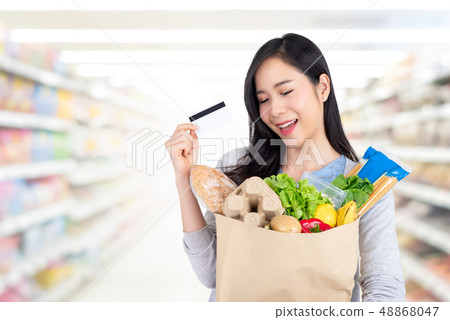 Beautiful Asian woman shopping groceries with Beautiful Asian woman shopping groceries with 48868047