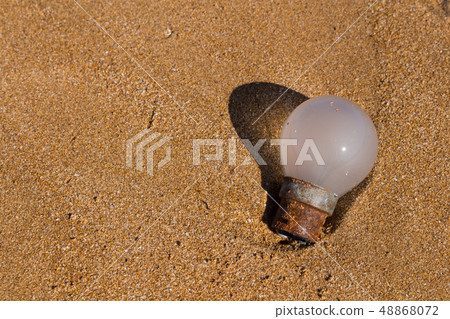 Ecology: beach discoveries - old rusted bulb Ecology: beach discoveries - old rusted bulb 48868072