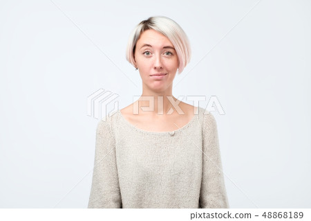 Doubt, mistrust, distrust concept. Doubtful woman looking with disbelief expression at studio. 48868189