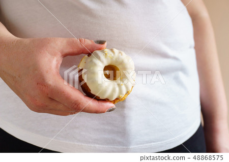 overweight woman with unhealthy fattening food overweight woman with unhealthy fattening food 48868575
