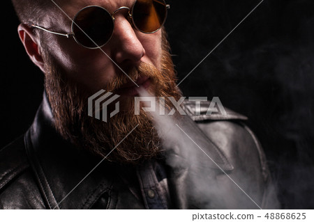 Low key portrait of attractive bearded man over black background 48868625