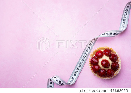 diet concept. sweet berry cake and measure tape 48868653