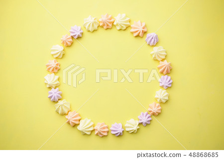 meringues on yellow background, food template 48868685