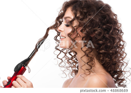 Beautiful brunette girl with a perfectly curly hair with curling, and classic make-up. Beauty face. 48868689