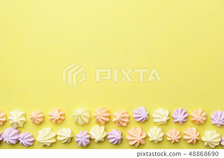 colorful meringue cookies on yellow background 48868690