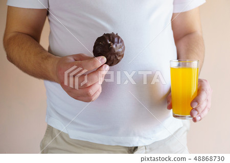 overweight man with unhealthy fattening food 48868730