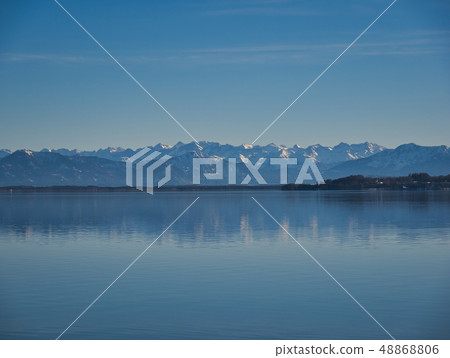 The mountains are reflected in the calm water 48868806