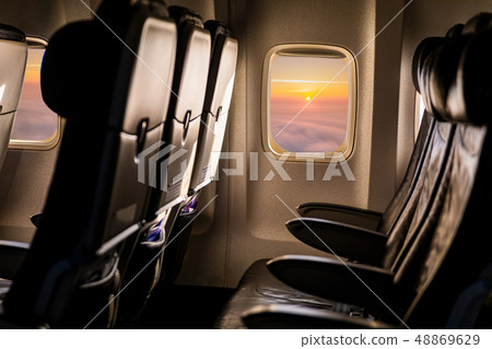 Empty airplane seats in the cabin in sunset light Empty airplane seats in the cabin in sunset light 48869629