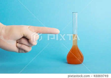 ecologist in protective gloves pointing on tube with dirty water. ecologist in protective gloves pointing on tube with dirty water. 48869749