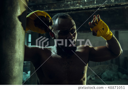 Hand of boxer over black background. Strength, attack and motion concept 48871051