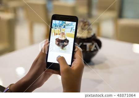 Woman taking a photo of dessert chocolate bingsu 48871064
