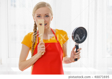 Woman holding cooking pan and spatula 48871695