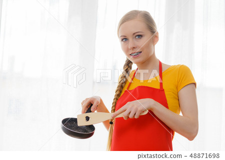Woman holding cooking pan and spatula 48871698