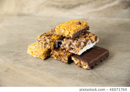 Various muesli bars on marble stone background Various muesli bars on marble stone background 48871769