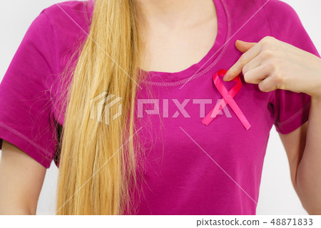 Woman having pink breast cancer ribbon on tshirt 48871833