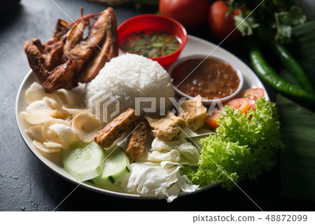Nasi lemak kukus with fried chicken Nasi lemak kukus with fried chicken 48872099
