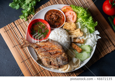 Fried pomfret fish and rice Fried pomfret fish and rice 48872135