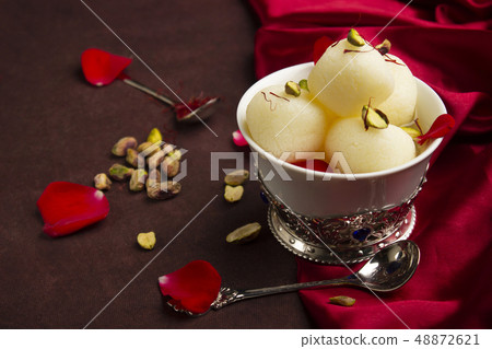 Bowl full with Rasgulla and pistachios, Pune India 48872621
