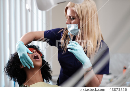 Young beautiful blond woman dentist at dentist's surgery 48873836